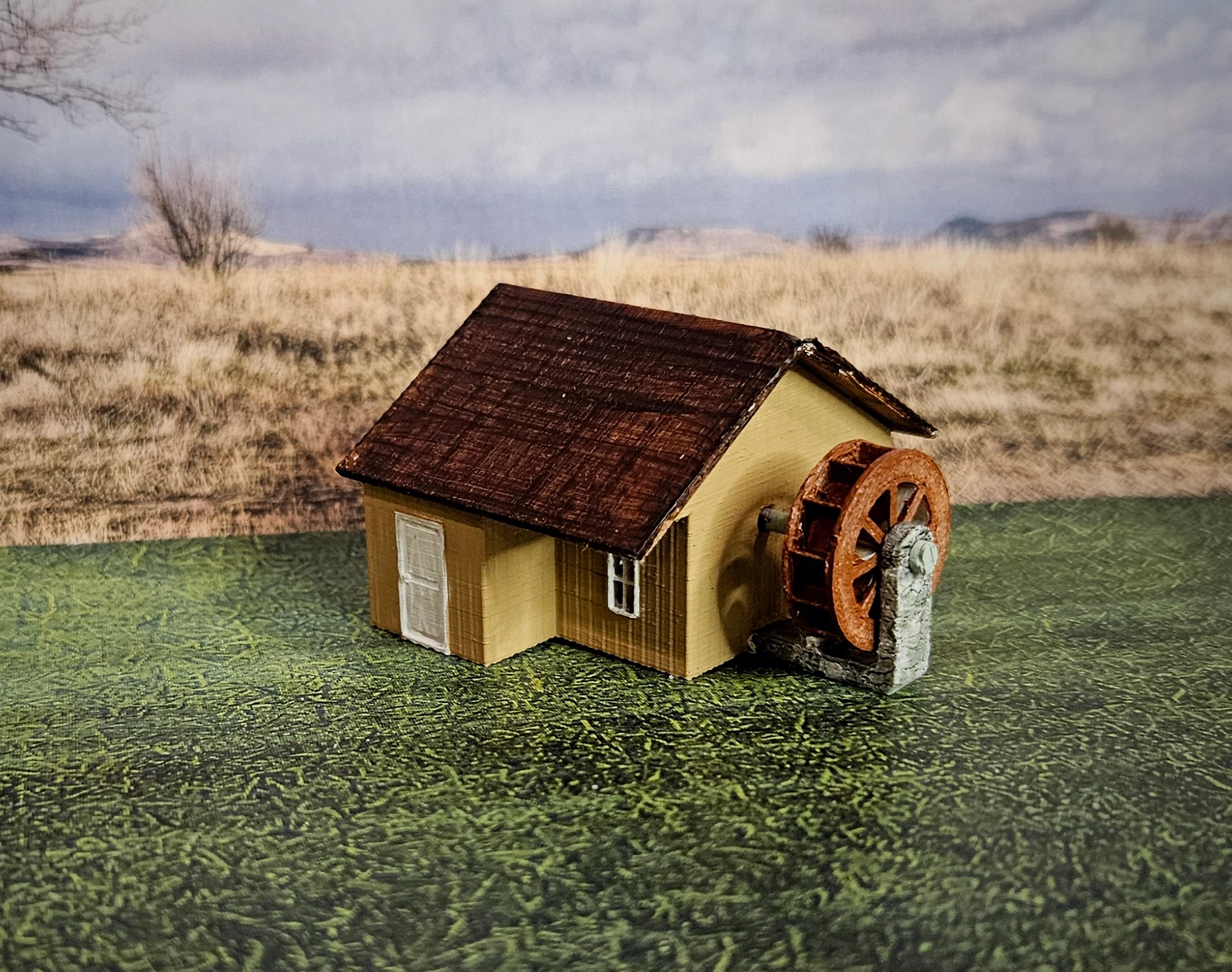 Angled view of HO scale waterwheel with large building